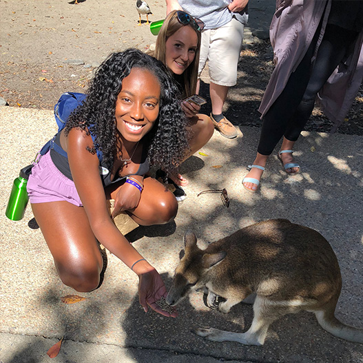 Two Girls Petting a Baby Kangaroo